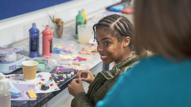 Student creating miniatures out of modelling clay